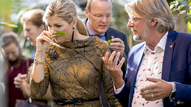 Queen Maxima enjoys the scent of fresh flowers on a visit to Koppert Cress